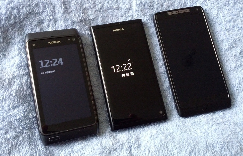 Three hand-sized smartphones